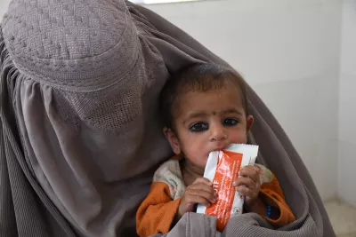 On 2 February 2022 in Afghanistan, a child eats a Ready-to-use therapeutic food (RUTF) before a malnutrition screening at Mirwais Regional Hospital a UNICEF-supported health facility.