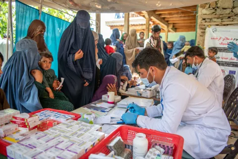 A doctor prescribes medicine to mothers and children at a UNICEF-supported mobile health and nutrition team (MHNTs) in Samsagal village, Nari District, Kunar, Afghanistan.