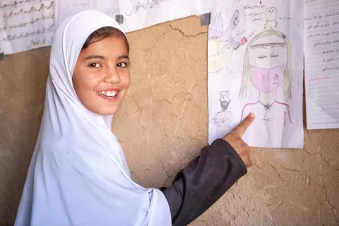 On 22 October 2023, 9-year-old Khadija shows one of her drawings in her community-based education class supported in Bagh-e-Jalal village, Daikundi province, central Afghanistan.
