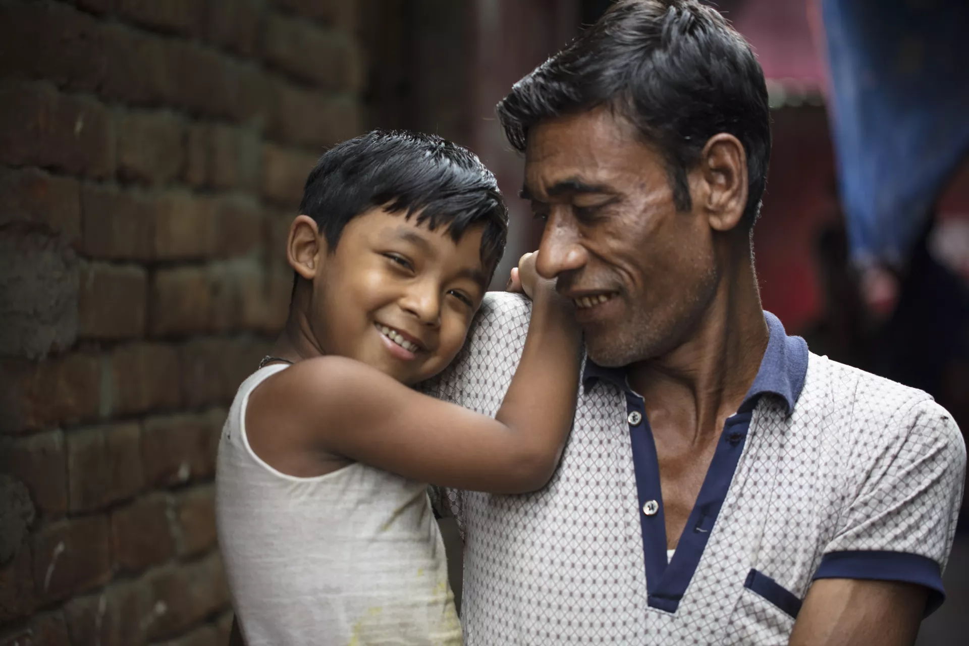 A Bangladeshi child and his father