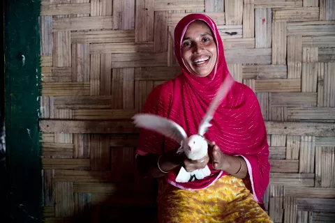 Taiyba, 31, holds a pigeon that she is raising at her home in Teknaf, Cox’s Bazar.