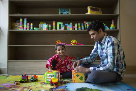 Jamal Hossain, 26, plays with his daughter Jui, in Bangladesh.