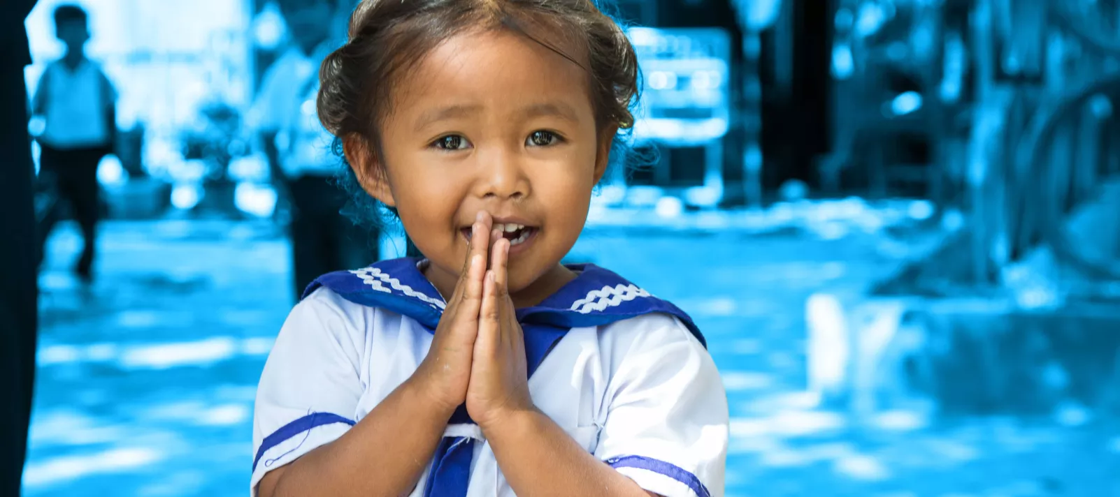 Truo Thary, three years old, preschool girl, is greeting UNICEF team.