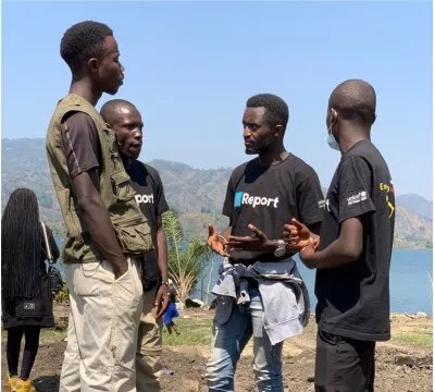 Moise Ashuza, a young champion in the second UNV cohort, takes part in an activity in Kalehe, in South Kivu, with the U-Report community in response to floods.