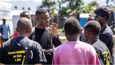 Anselme, a young UNICEF LINV, meets with young people in Bulengo IDP camp. His work involved empowering them to become agents of positive change in their community despite the challenges.