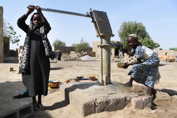 Two girls are gathering water at a well in Ndjamena, the capital of Chad. For every child, clean water.