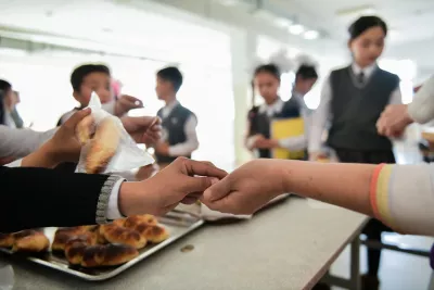 Children buy fried snacks at school