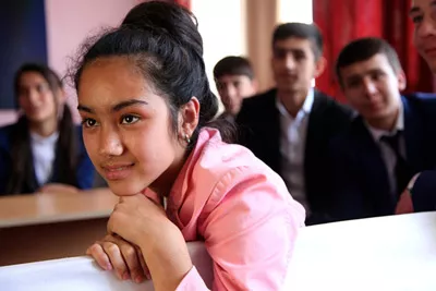 A female student attends a networking meeting at a school in Tajikistan.