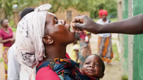 A young mother holding a son receive cholera vaccination in muwiza village, Vubwi District in Eastern Province Zambia.