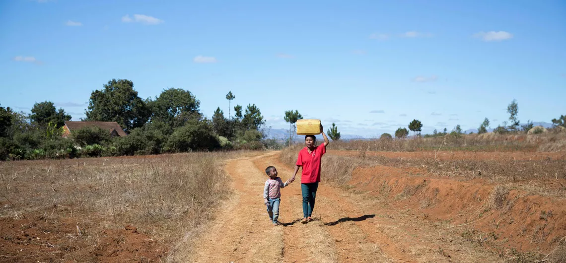 Gina walks to fetch water with her 5-year-old son, Rindra, in Antsirabe, Madagascar.