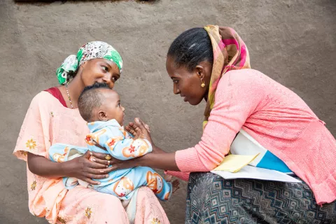 Health worker Amelework Getachew examines five months old Aziza. 