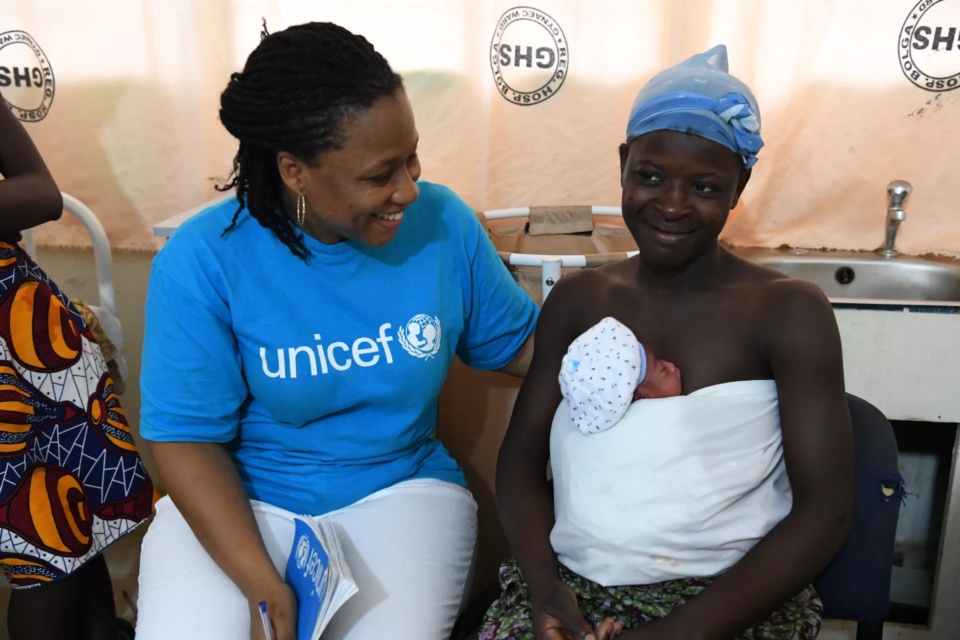 UNICEF staff member with a beneficiary.