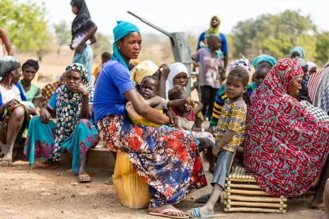 Senatu Amadu sitting with community in camp in Sapelliga, Upper East Region, February 2023