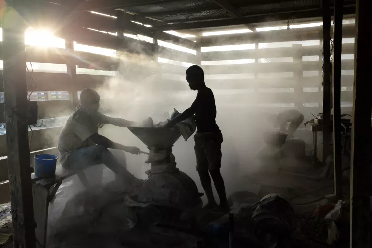 Abdul Aziz (right), 13 years old and in Grade five, working in an informal gold processing facility in the Brong Ahafo region of Ghana where ore from illegal "galamsey" mines is processed. Child labour is common, both as a result of poverty and because of the lure of quick money.