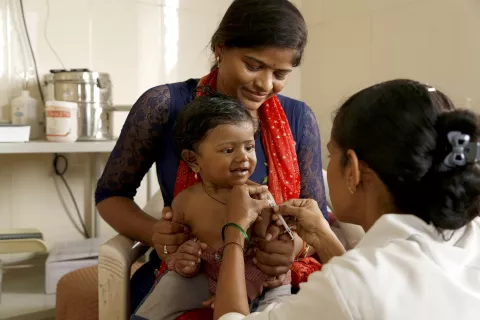 Doctor giving vaccine to a child.