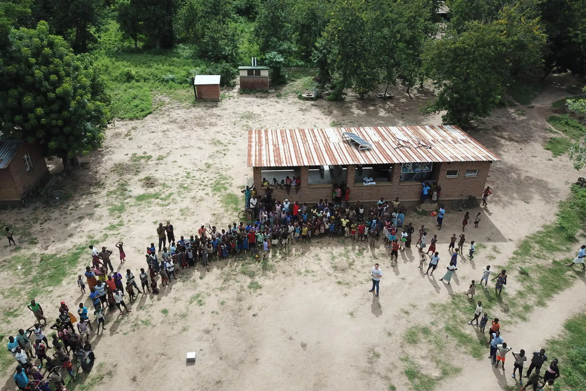 After the mapping mission, UNICEF’s drone coordinator Tautvydas Juskauskas takes off the drone for the last time to make a drone selfie with the community members.