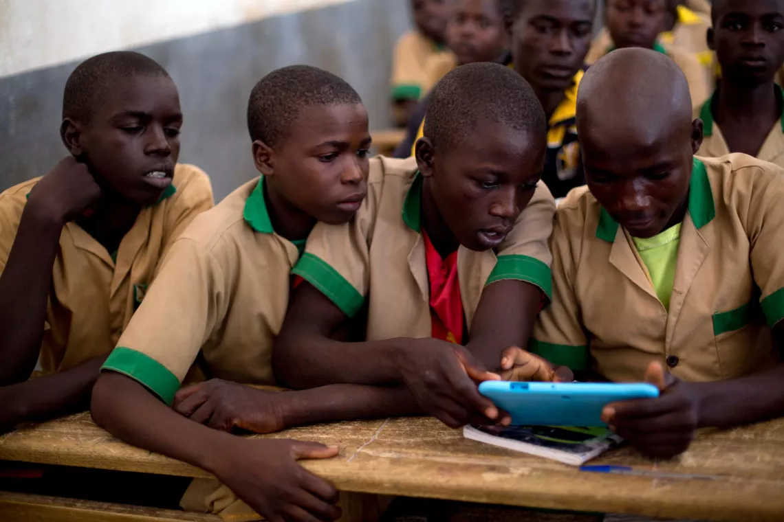 Students learn with the help of a computer tablet provided by UNICEF at a school in Baigai, northern Cameroon.