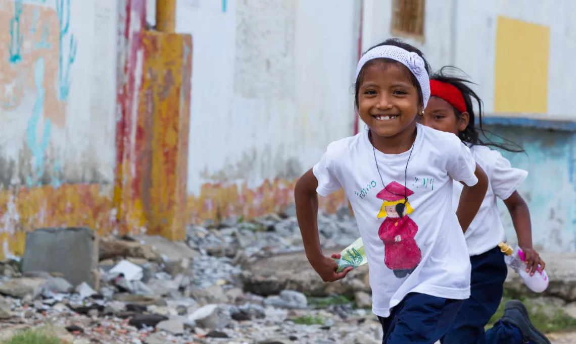 Two girls running in Guarero (Zulia, Venezuela). UNICEF Venezuela works to improve the quality of education for the most vulnerable children and adolescents from indigenous communities in the states of Amazonas, Bolívar, Delta Amacuro and Zulia.