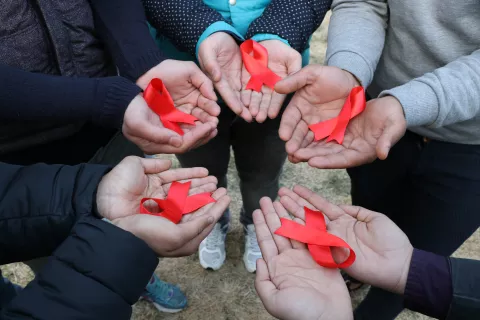 Children with red ribbon in hands 