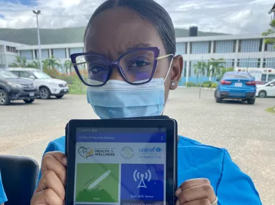 Photograph of Yonique Malcolm, a community health worker using the CommCare digital health platform at the St Joseph’s Hospital vaccination site in Kingston. 