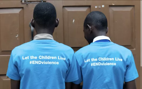 Boys wearing end violence against children t-shirts
