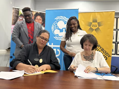 Photograph of Saffrey Brown (left), Project STAR Project Director and Olga Isaza, UNICEF Jamaica Representative sign a Memorandum of Understanding between the two organisations at a signing event held  at the Private Sector Organisation of Jamaica’s (PSOJ) office on Hope Road in Kingston on Tuesday, April 18 2023. Looking on are Project STAR Youth programme officer, Hykel Nunes and FunDoo Project Manager, Danielle Mullings.