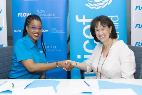 Photograph of Kayon Mitchell (left), Flow’s Director of Communications and Executive Director of the Flow Foundation and Olga Isaza, UNICEF Jamaica Representative, re-sign the Memorandum of Understanding between the two organisations at Flow’s headquarters in Kingston 