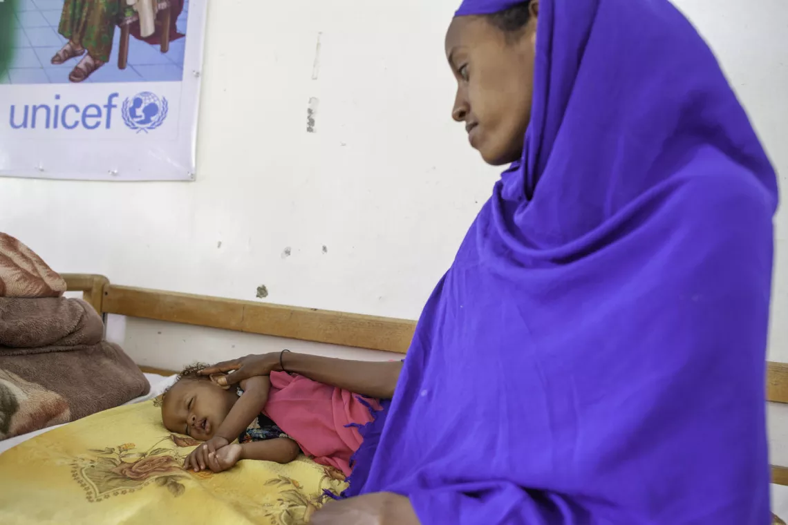 A mother comforts her severely malnourished child at stabilisation centre in Hargeisa, Somaliland.