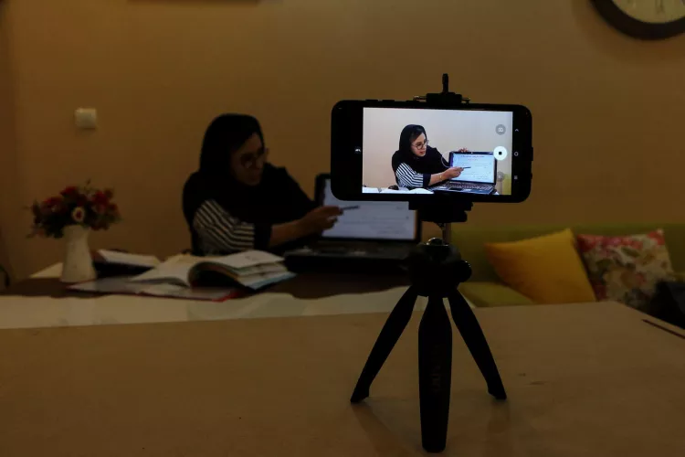 A teacher in Ahvaz, Iran, records and sends educational videos to her students so that they can continue their studies virtually.