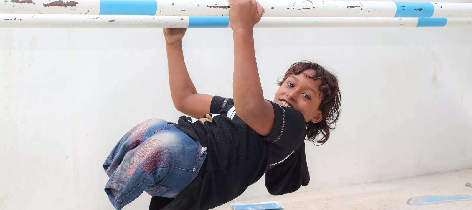 Emad, 11, uses the balance beam in the prosthetic centre in Aden, Yemen on 14 October 2021.