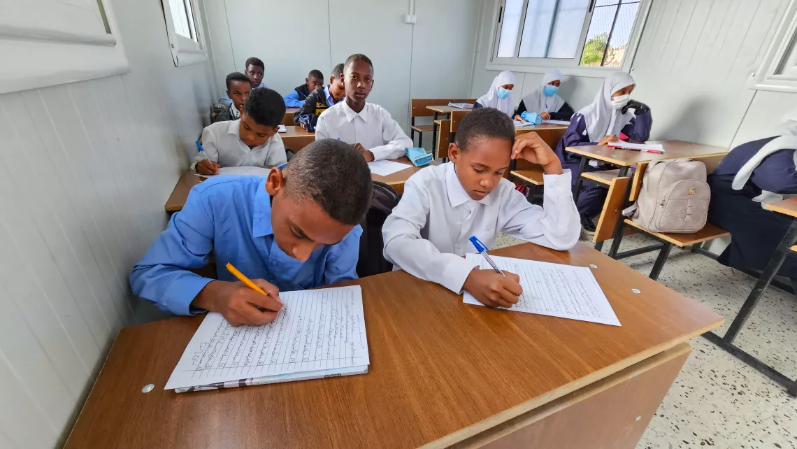 Students engage in their lessons inside the prefabricated classroom at Taqrouteen School. Photo: ©UNICEF/Wadi Otbah/2023/Abdullah Hussein