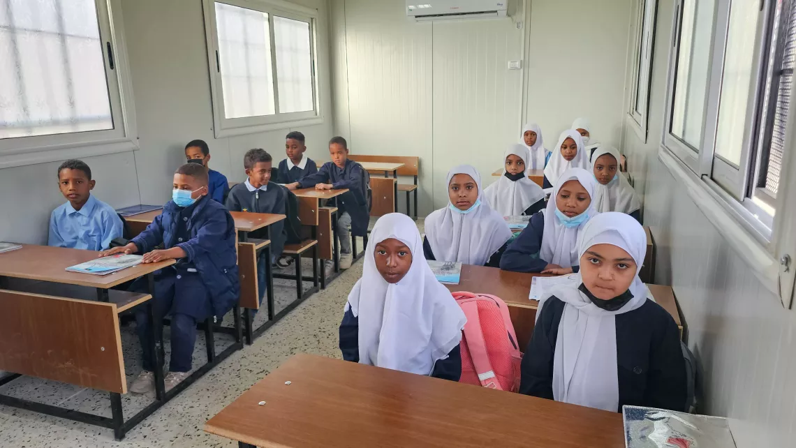 Aliya, (a girl, second row on the left), with other students, focused and attentive in her seat, embodies the spirit of perseverance that fills the modernized classroom at Taqrouteen School.