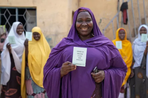 A voluntary community mobilizer holding her immunization card 