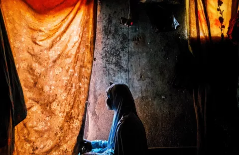 A girl looks out of a window in northeast Nigeria