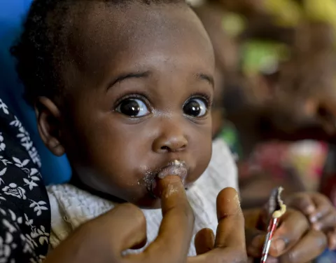 A child being fed with RUTF