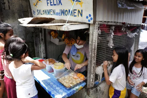 Children flock to buy pichi-pichi, a snack made from grated cassava, grated coconut, and sugar to taste.
