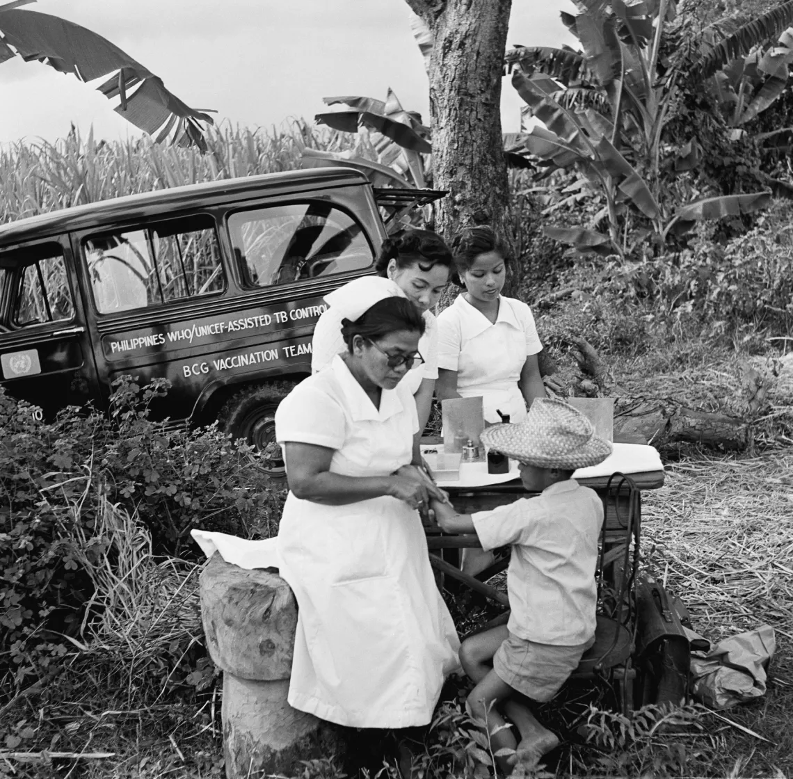 Black-and-white archival photo of nurses testing a boy for tuberculosis