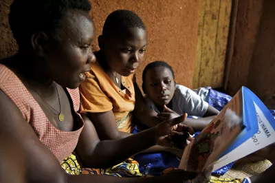 Family in Rwanda reads book with children