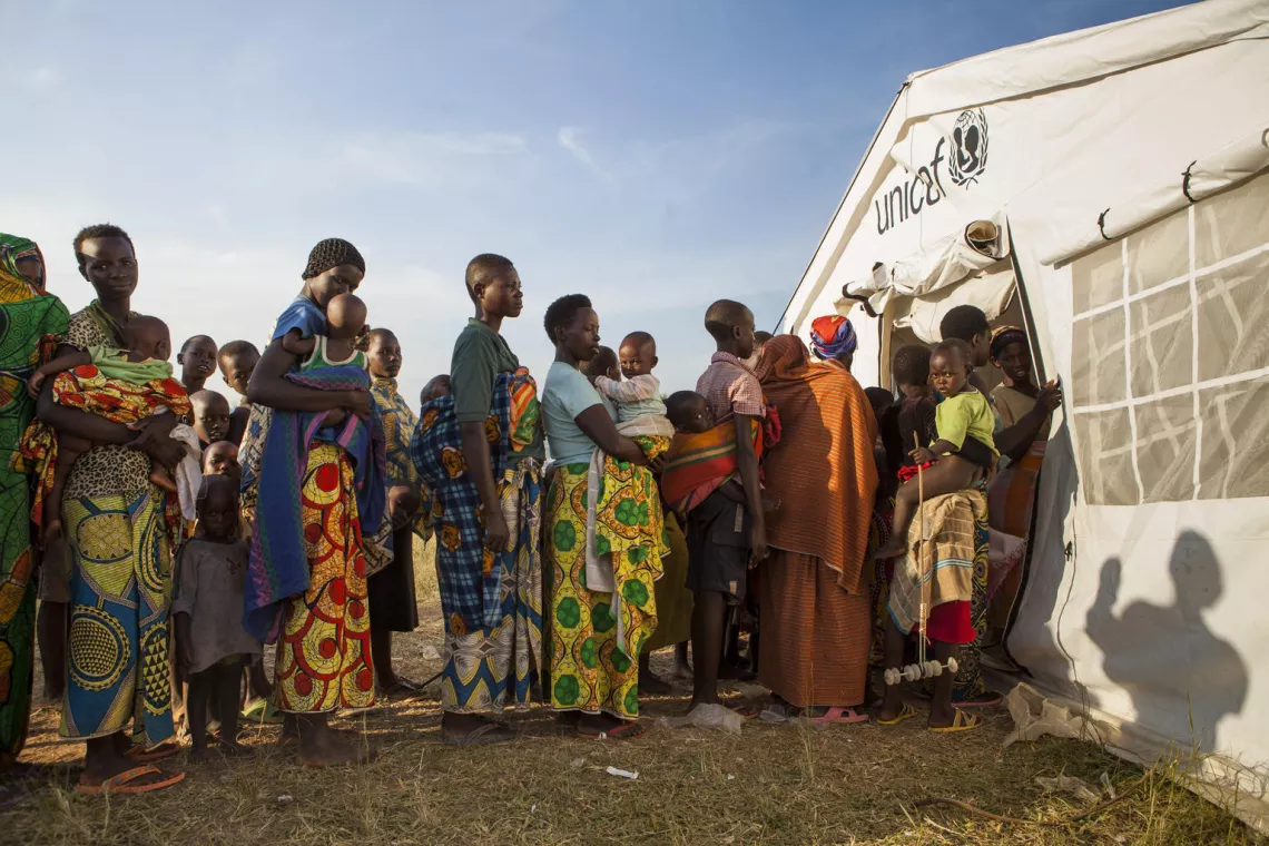 Burundian refugees line up to receive vaccines against measles and polio. UNICEF provides these vaccines, along with Vitamin A supplements to fight malnutrition, to all children in Mahama Camp. 