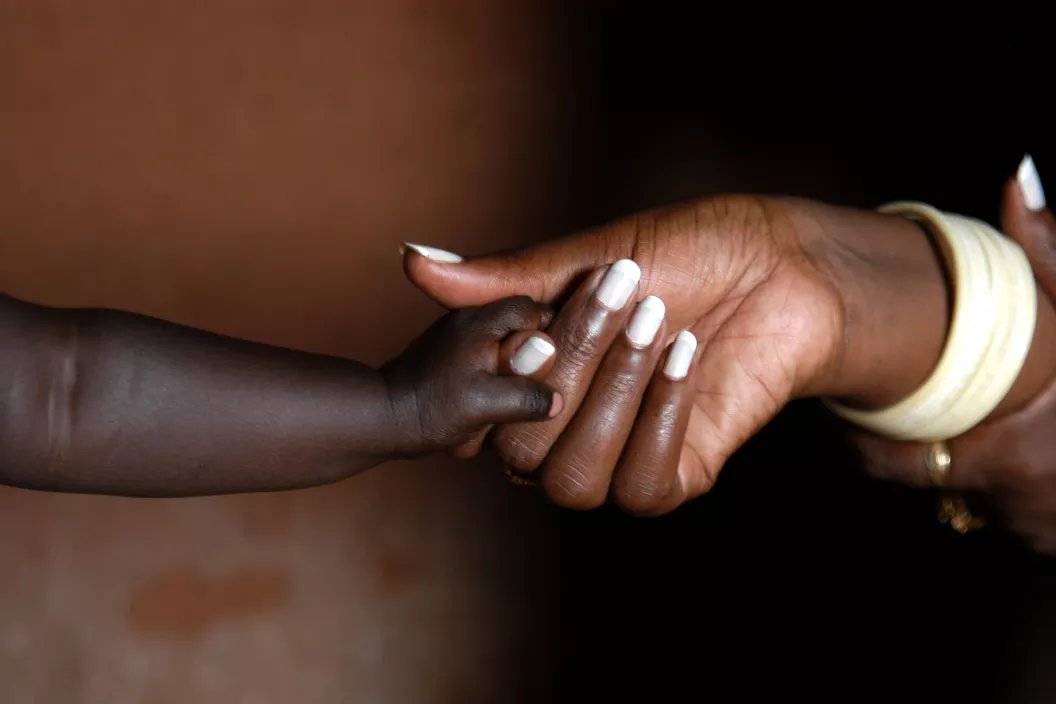 Two hands of mother and baby in Rwanda