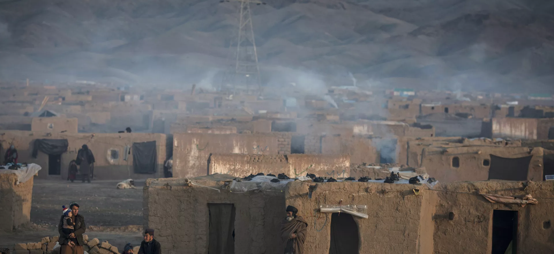 Smoke rises from the chimneys of hundreds of homes in an internally displaced camp on the outskirts of the western city of Herat, Afghanistan