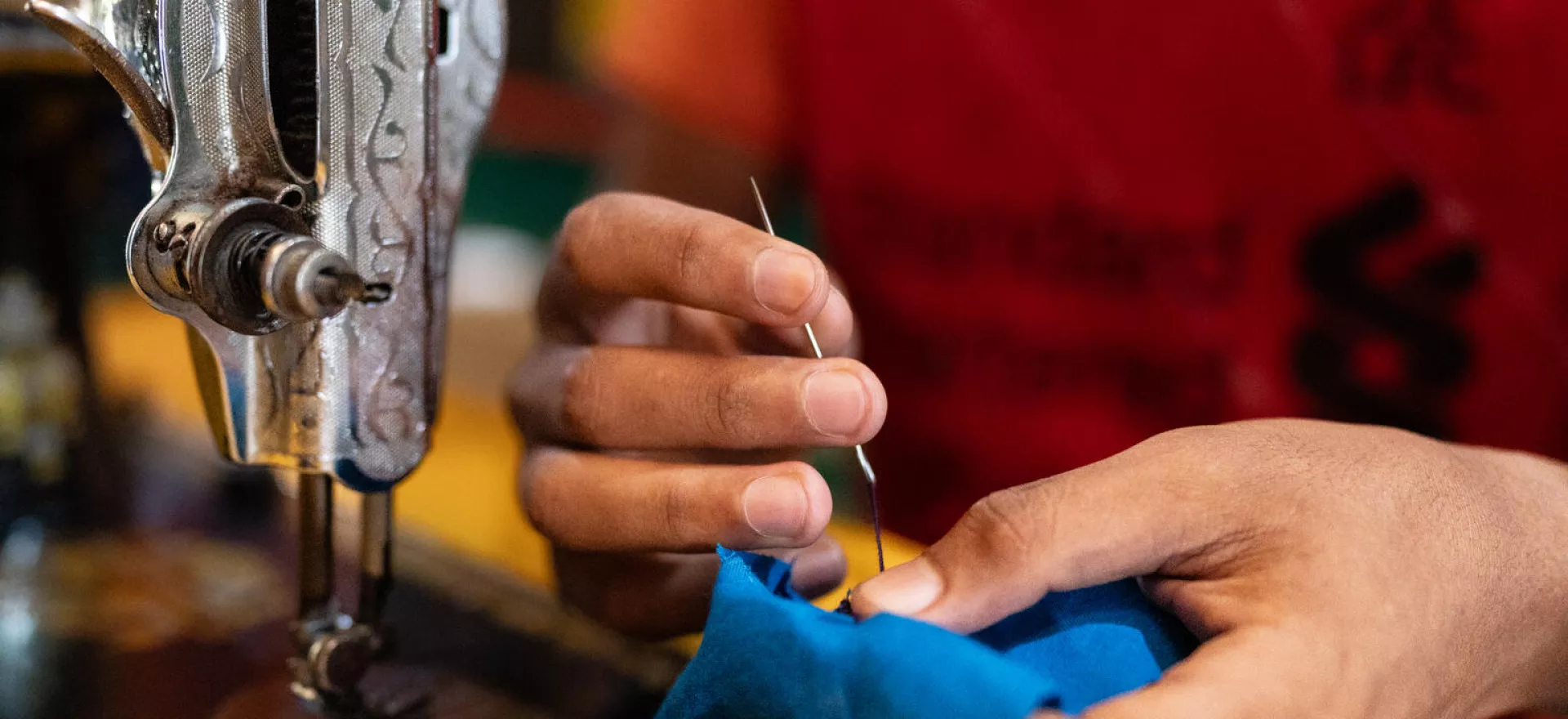 Bangladesh. A boy sews an item of clothing as part of a tailoring workshop at a Multi-Purpose Centre in a Rohingya refugee camp in Cox’s Bazar, Bangladesh