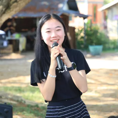 Girl smiling with a microphone on her hand