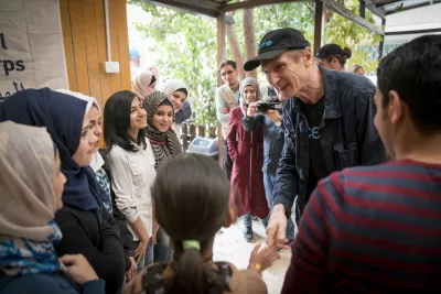 UNICEF Goodwill Ambassador Liam Neeson talks to young actors after watching their performance during a visit to a Makani centre in Mafraq, Jordan on Nov 7, 2016.