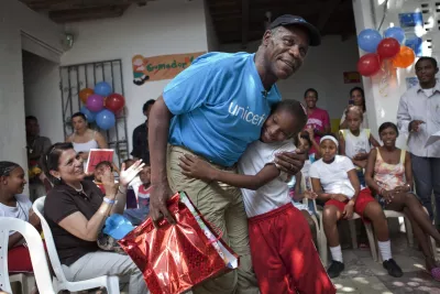 UNICEF Goodwill Ambassador Danny Glover embraces a girl who has presented him with a gift, at the La Boquilla centre in Cartagena, capital of Bolivar Department, in Colombia, 2011.