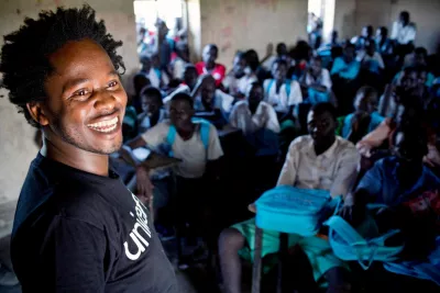 In 2015, UNICEF Goodwill Ambassador Ishmael Beah meets children, some of whom were formerly associated with armed groups, at a school supported by UNICEF in Pibor, South Sudan.