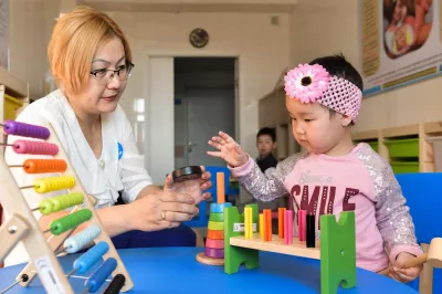Inzhu, 2 years, playing and discovering new toys with trained coordinator of the PNS resource center in Turkestan.