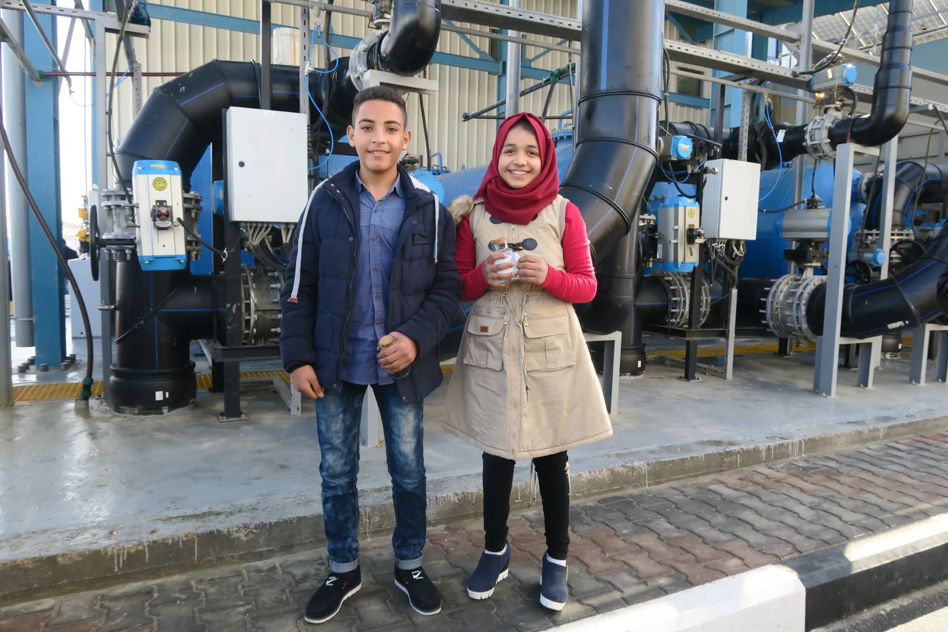 Children stand in the new seawater desalination plant, Gaza
