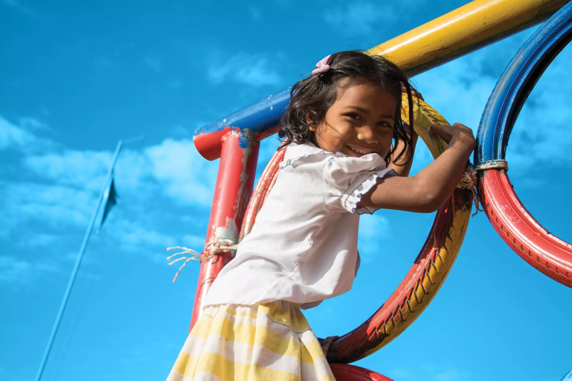 A girl plays in the playground at Srae Tahen primary school, Cambodia