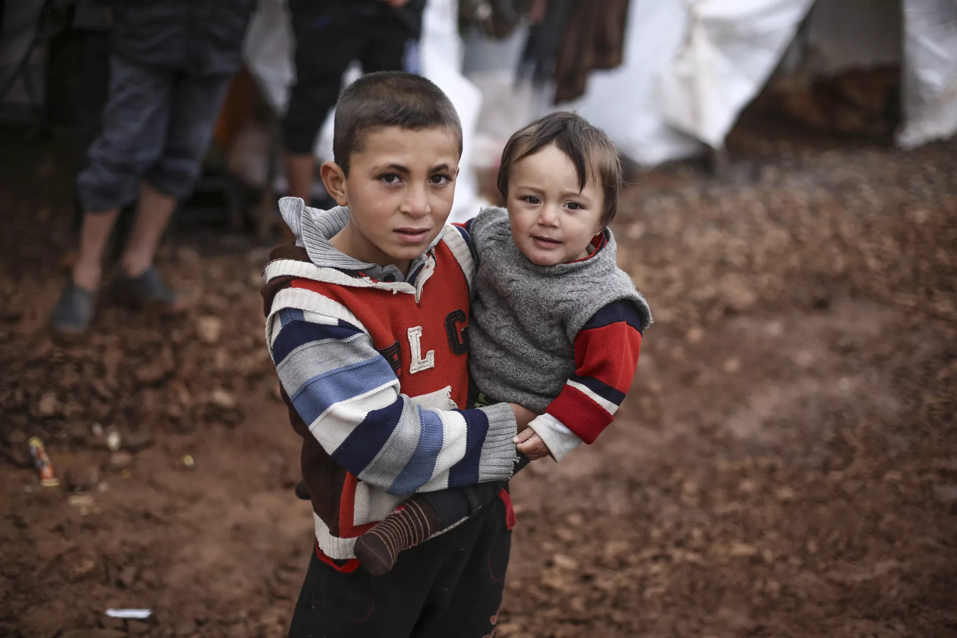 Syria. Two children stand outside tents at an informal settlement close to the Syrian-Turkish border,